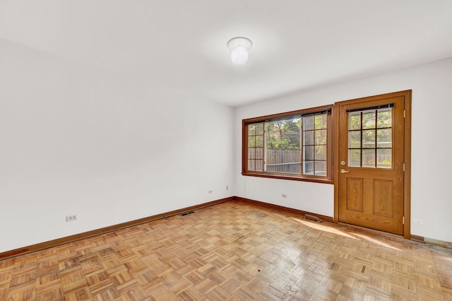 unfurnished room featuring baseboards