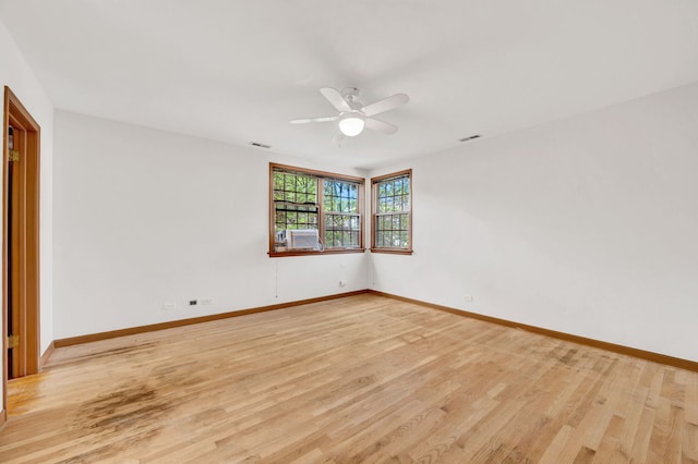 unfurnished room featuring a ceiling fan, baseboards, and light wood-style floors