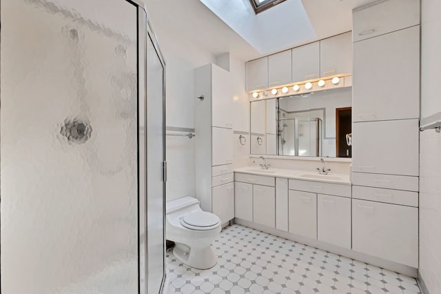 full bath featuring a skylight, a shower stall, toilet, double vanity, and tile walls