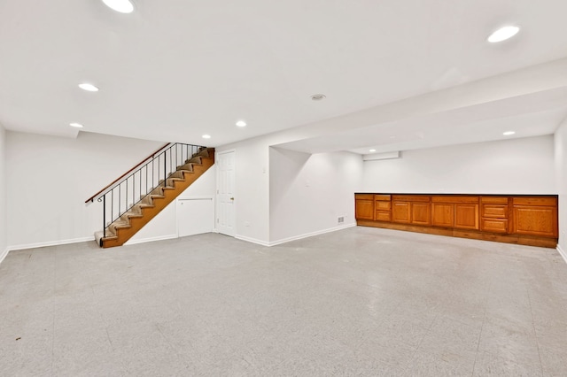 finished basement featuring stairs, recessed lighting, and baseboards