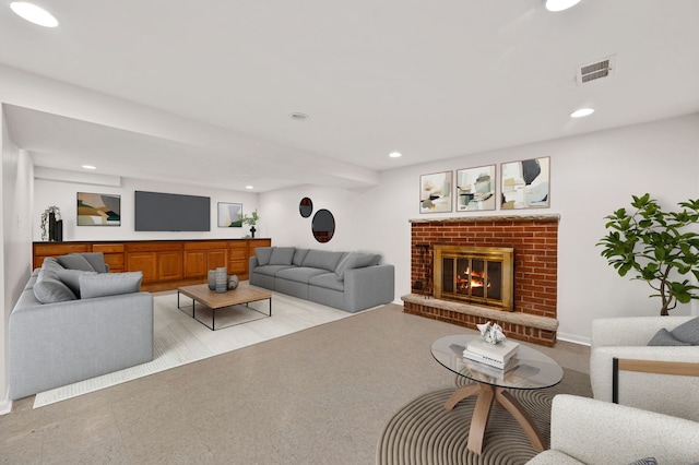 living room with recessed lighting and a brick fireplace