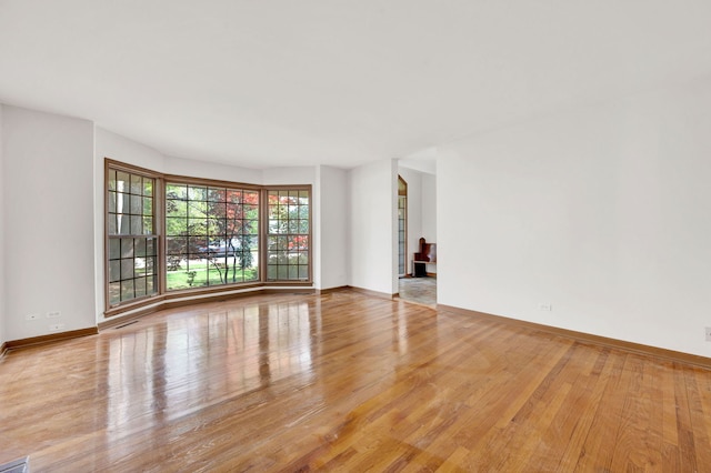 empty room with wood finished floors and baseboards