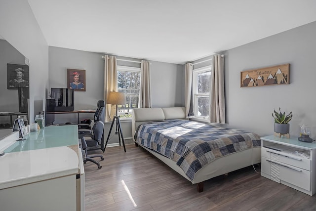 bedroom with baseboards and wood finished floors
