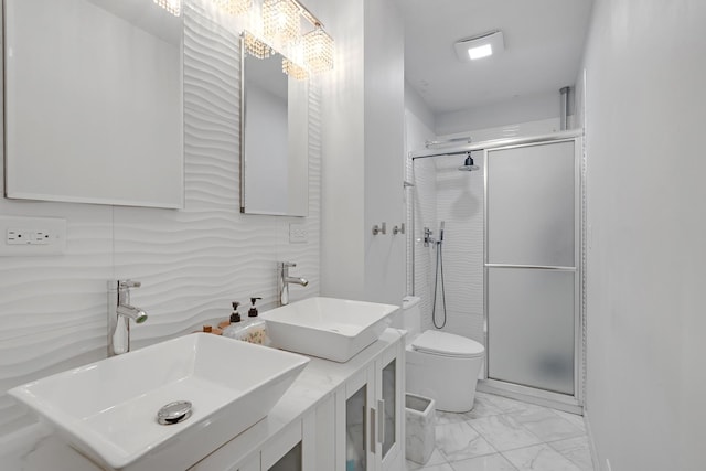 bathroom with a sink, toilet, a shower stall, and marble finish floor