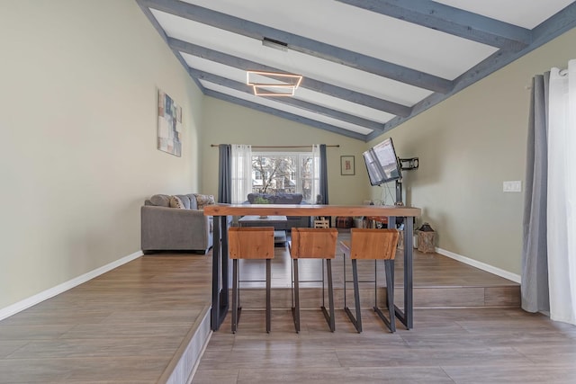 bar with wood finished floors, lofted ceiling with beams, and baseboards