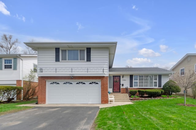 split level home with brick siding, driveway, an attached garage, and a front lawn