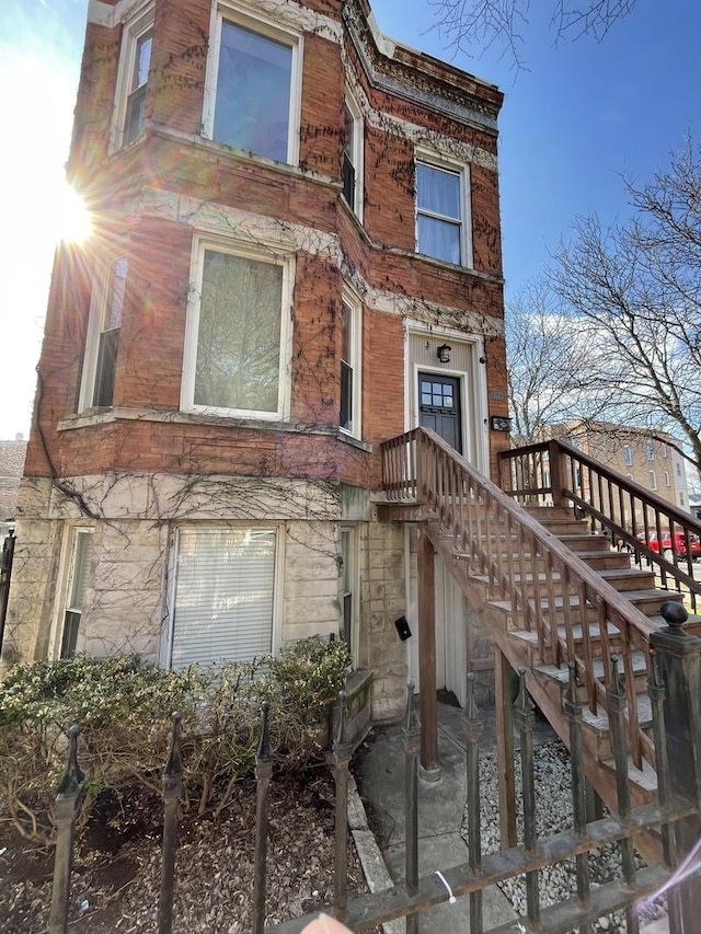 1022 N Rockwell St, Chicago, IL 60622 - exterior space with brick siding, stone siding, and stairs