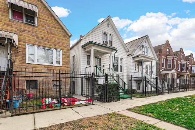 2225 S Kirkland Ave, Chicago, IL 60623 - view of front facade featuring a residential view, stone siding, and a fenced front yard