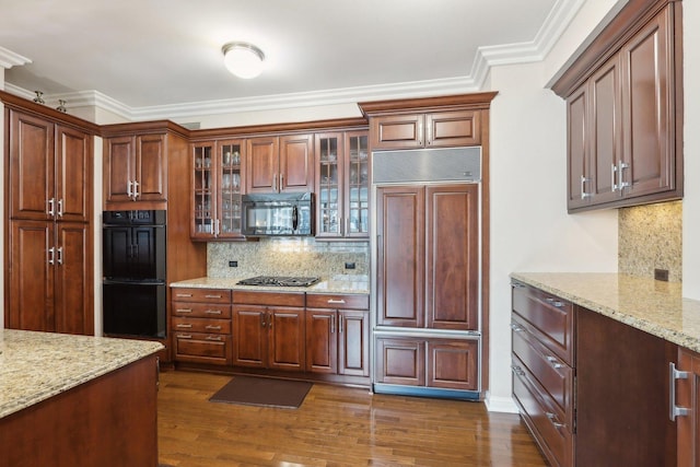 kitchen featuring crown molding, dark wood-style flooring, backsplash, and black appliances