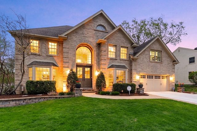 view of front of property with an attached garage, concrete driveway, a front yard, and brick siding