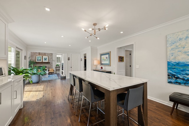kitchen with an inviting chandelier, a wealth of natural light, and dark wood finished floors
