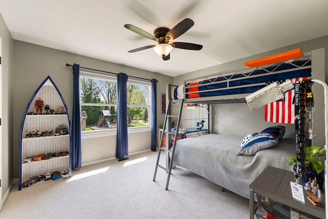 carpeted bedroom with baseboards and a ceiling fan