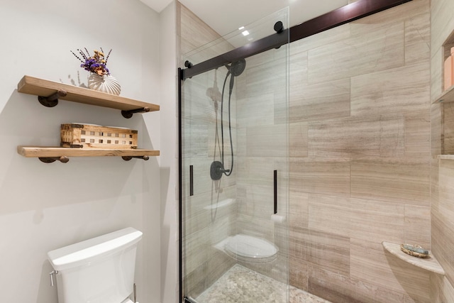 full bath with toilet and a shower stall