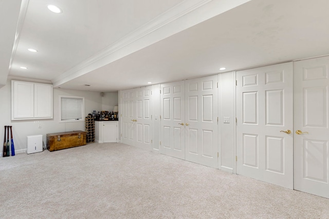 finished below grade area with carpet floors, recessed lighting, baseboards, and crown molding