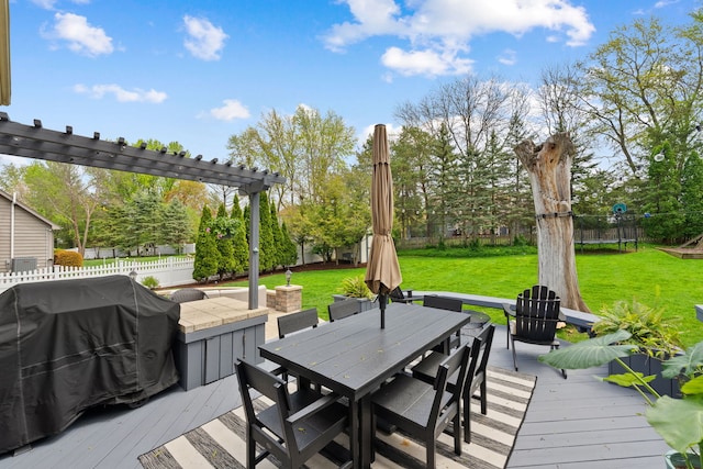 wooden terrace with outdoor dining area, a lawn, fence, and a grill