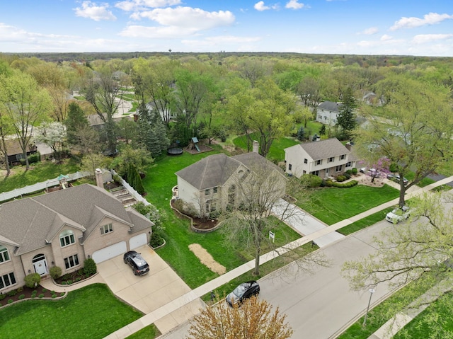 drone / aerial view featuring a wooded view