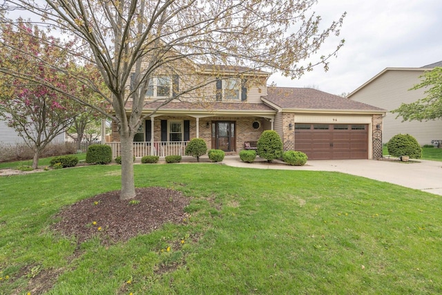 traditional-style home with a garage, a front yard, brick siding, a porch, and driveway