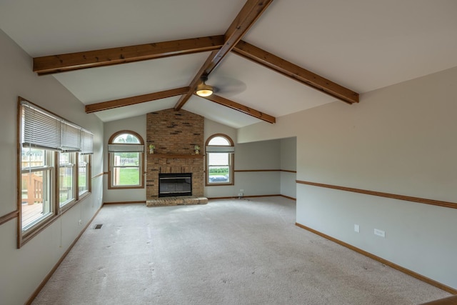 unfurnished living room with ceiling fan, lofted ceiling with beams, a brick fireplace, carpet, and baseboards