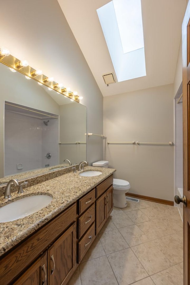 full bath featuring toilet, visible vents, a sink, and vaulted ceiling with skylight