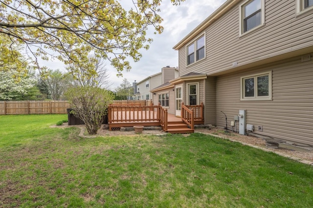 view of yard featuring fence and a deck