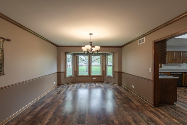 unfurnished dining area featuring visible vents, crown molding, baseboards, dark wood-type flooring, and a chandelier