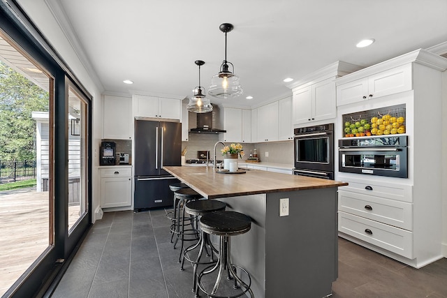 506 Aberdeen Rd, Frankfort, IL 60423 - kitchen featuring high quality fridge, butcher block counters, wall chimney range hood, tasteful backsplash, and recessed lighting