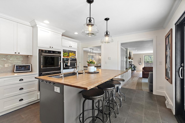 506 Aberdeen Rd, Frankfort, IL 60423 - kitchen featuring wooden counters, a sink, an island with sink, white cabinetry, and recessed lighting