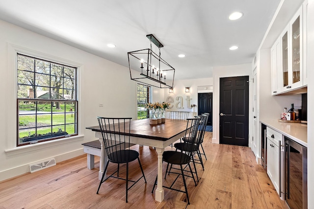 506 Aberdeen Rd, Frankfort, IL 60423 - dining room with wine cooler, light wood-style flooring, a bar, recessed lighting, and baseboards
