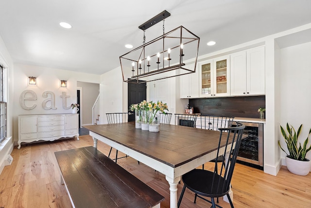 506 Aberdeen Rd, Frankfort, IL 60423 - dining space featuring wine cooler, light wood finished floors, recessed lighting, baseboards, and stairway