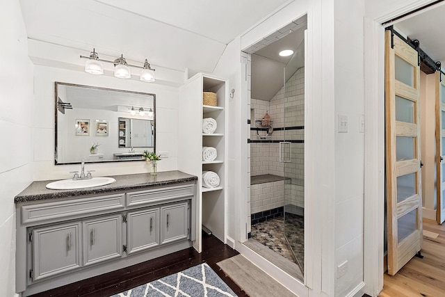 506 Aberdeen Rd, Frankfort, IL 60423 - full bathroom featuring wood finished floors, tiled shower, vanity, and vaulted ceiling