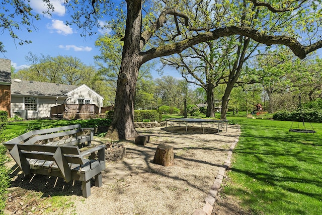 506 Aberdeen Rd, Frankfort, IL 60423 - view of grassy yard featuring a trampoline and a deck