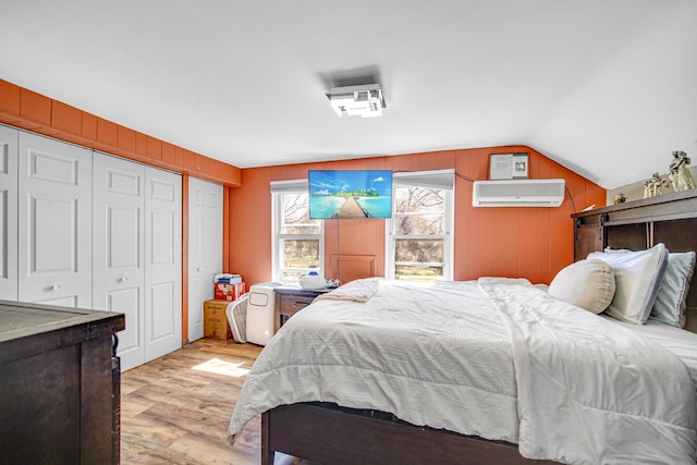 824 Rowlett Ave, Melrose Park, IL 60164 - bedroom with an AC wall unit, a closet, light wood-style floors, and lofted ceiling