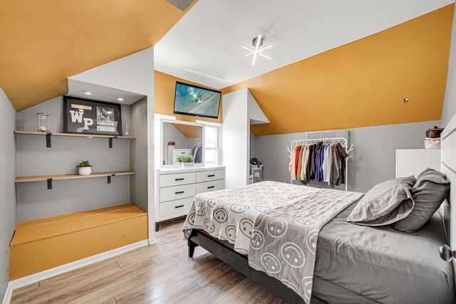 824 Rowlett Ave, Melrose Park, IL 60164 - bedroom with baseboards, light wood-type flooring, and vaulted ceiling