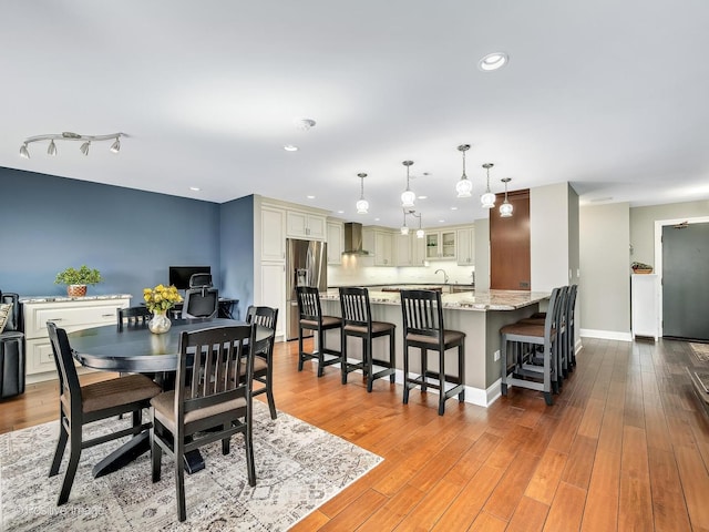 dining room with baseboards, recessed lighting, and wood finished floors