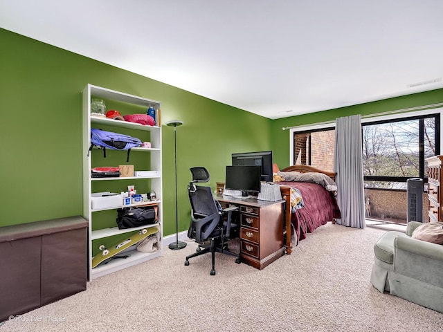 carpeted office with visible vents and plenty of natural light