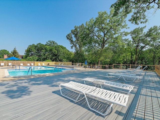 pool featuring fence and a patio