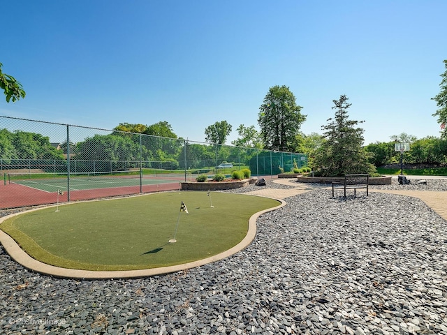 surrounding community with fence and a tennis court
