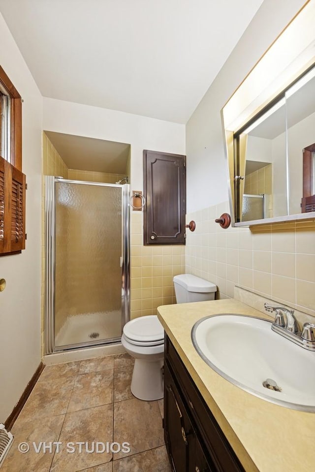 unfurnished room featuring wood-type flooring, baseboards, and visible vents