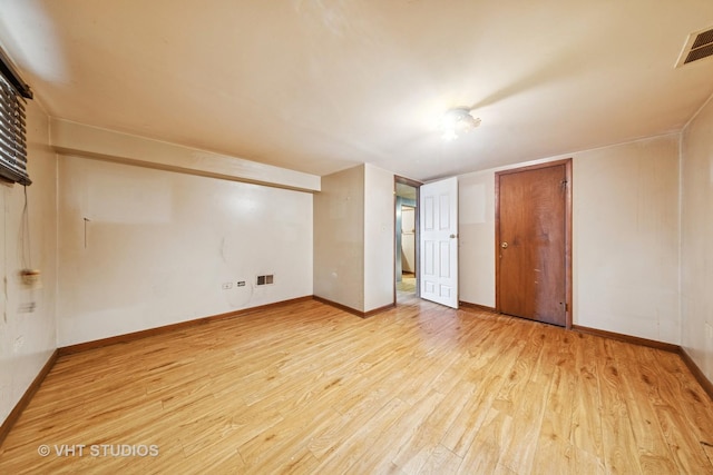 finished below grade area featuring a fireplace, wood walls, wood finished floors, and stairs