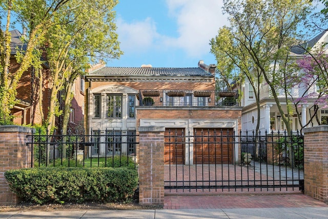 579 W Hawthorne Pl, Chicago, IL 60657 - view of front of property featuring a balcony, a fenced front yard, a garage, and a tile roof