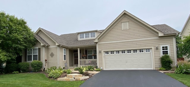 459 E Amberside Dr, Elgin, IL 60124 - view of front facade with a porch, asphalt driveway, roof with shingles, a garage, and a front lawn