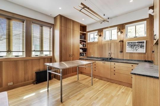 351 W Belden Ave, Chicago, IL 60614 - kitchen featuring wooden walls, open shelves, dark countertops, light wood-style floors, and radiator