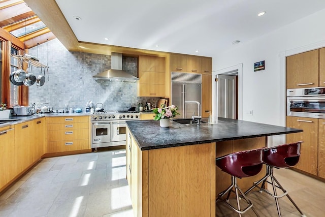351 W Belden Ave, Chicago, IL 60614 - kitchen with wall chimney exhaust hood, a breakfast bar, a sink, premium appliances, and decorative backsplash