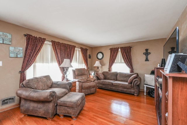 living area featuring visible vents, baseboards, and light wood-type flooring