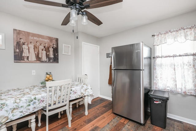 dining area featuring dark wood-style floors, baseboards, and ceiling fan