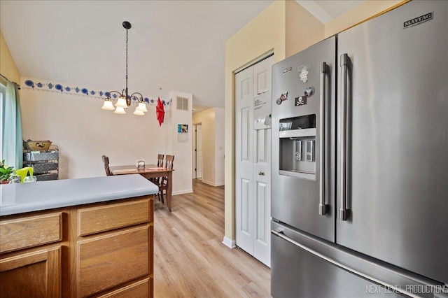 19 Vernon Ct, South Elgin, IL 60177 - kitchen with high end refrigerator, light wood-style floors, a chandelier, brown cabinets, and decorative light fixtures