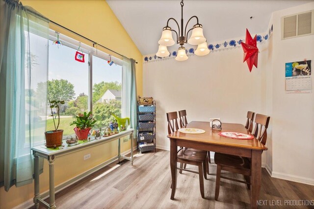 19 Vernon Ct, South Elgin, IL 60177 - dining space featuring a chandelier, wood finished floors, and vaulted ceiling