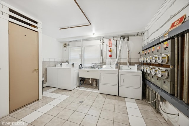 205 Circle Ave Unit 2B, Forest Park, IL 60130 - shared laundry featuring separate washer and dryer, light tile patterned floors, and tile walls