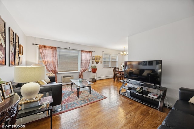 205 Circle Ave Unit 2B, Forest Park, IL 60130 - living area with a chandelier, wood finished floors, a wall unit AC, and baseboards