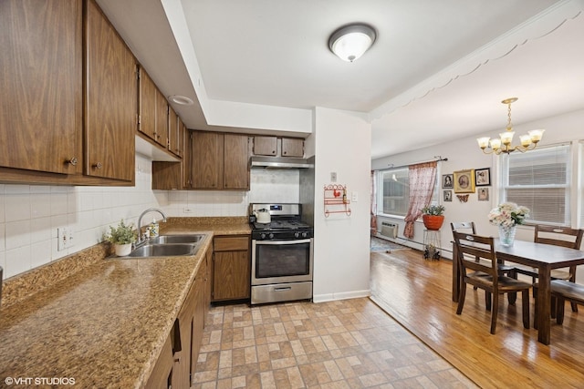 205 Circle Ave Unit 2B, Forest Park, IL 60130 - kitchen featuring stainless steel range with gas stovetop, under cabinet range hood, a sink, and backsplash